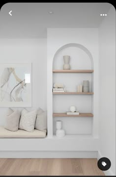 a room with white walls and shelves filled with vases, bookshelves and other items