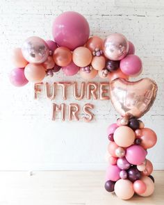 a balloon arch with the words future mrs on it