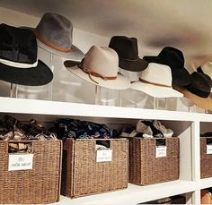 hats are lined up on shelves in the closet