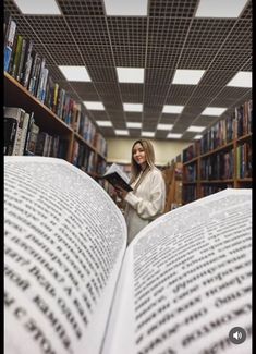 a woman reading a book in a library