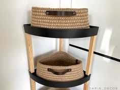 three baskets are stacked on top of each other in a room with white walls and black trim