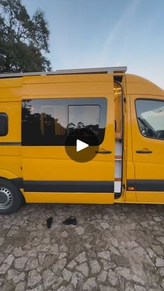 a yellow van parked on top of a cobblestone road