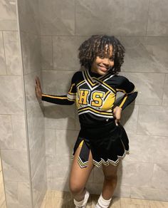 a woman in a cheerleader costume posing for the camera