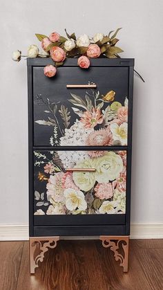 a black dresser with flowers painted on it