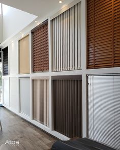 an empty room with wooden blinds on the wall