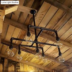 a chandelier made out of wood and glass bulbs