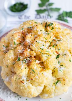 cauliflower on a plate with parmesan cheese and herbs