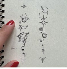 a hand is holding a notebook with drawings on it and the pages are lined up