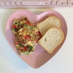 a heart shaped plate with toast and an omelet