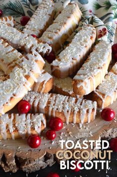 toasted coconut biscuits with white icing and cranberries on a platter