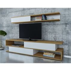 an entertainment center with bookshelves and a flat screen tv mounted on the wall