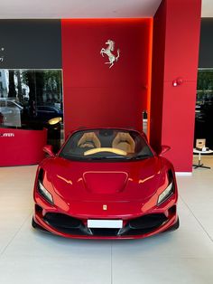 a red sports car is parked in the showroom