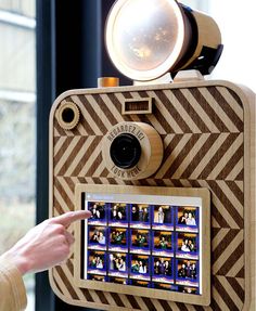 a person pointing at a camera with pictures on it