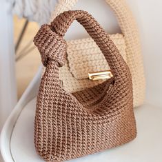 a crocheted purse sitting on top of a white table