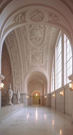 an ornate hallway with marble floors and arches