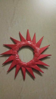 a red paper wreath with spikes on it