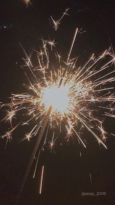 fireworks are lit up in the night sky with bright lights and sparklers all around