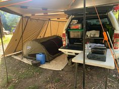 a van with a tent and laptop in the back