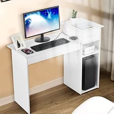 a white computer desk with a monitor and keyboard