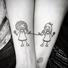 two girls with matching tattoos holding hands