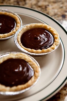 four mini chocolate pies on a plate