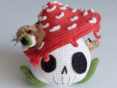 a crocheted skull with a red hat on it's head and eyes