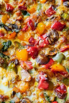 a pizza with lots of different toppings on it's crust, including peppers and mushrooms