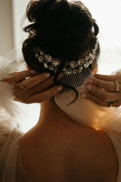 the back of a woman's head with hair comb in her hand