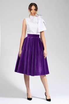 This purple velvet circle skirt is a must-have for any woman's wardrobe. It's made from 100% cotton, so it's both soft and elegant. The skirt has a high waist and a full circle skirt, which gives it a flattering and feminine look. The skirt is also lined, so it's comfortable to wear. This skirt is perfect for any occasion, from a night out to a special event. It can be dressed up or down, depending on the occasion. The purple color is versatile and can be paired with a variety of tops and access Cotton Long Skirt For Party, Chic Velvet Party Skirt, Elegant Purple Knee-length Skirt, Purple Pleated Skirt For Party, Elegant Velvet Party Skirt, Party Pleated Cotton Skirt, Party Full Skirt In Cotton, Flared Cotton Skirt For Party, Cotton Full Skirt For Party