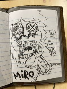 an open notebook with a drawing of a zombie face on it and the words niro written in black ink