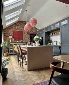 an image of a kitchen with lots of counter space and chairs on it's side