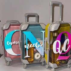 three pieces of luggage with the letters q, n, and d on them sitting next to each other