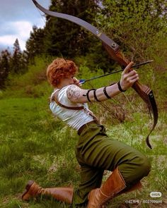 a woman with red hair is shooting an arrow