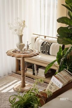 a living room filled with furniture and plants