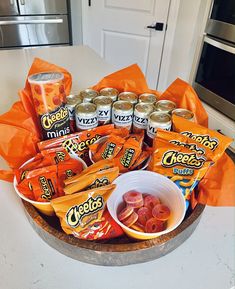 a wooden bowl filled with chips and candy