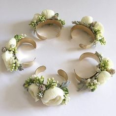 four pieces of paper with flowers and leaves on them are arranged in the shape of a circle