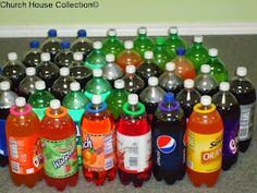 a bunch of soda bottles lined up on the floor