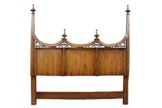 a wooden bed frame with four posts and two headboards on each side, against a white background