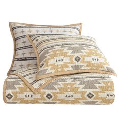 two pillows on top of each other with an orange and white pattern in the middle