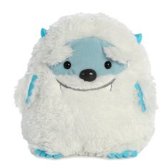 a white and blue stuffed animal with big eyes