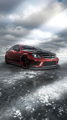 a red sports car parked in the middle of an ice covered field under a cloudy sky