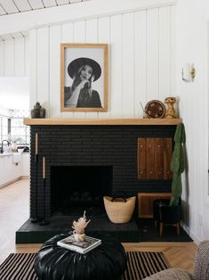 a living room with a fireplace and pictures on the wall