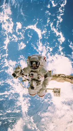 an astronaut floating in the sky above earth