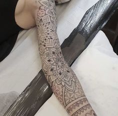 a person with a tattoo on their arm holding a knife