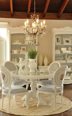 a dining room table with chairs and a chandelier