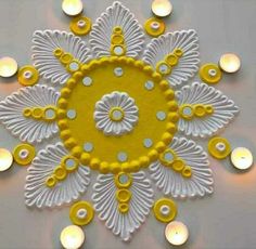 an intricate yellow and white design with candles