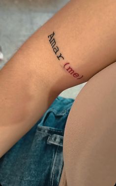 a woman with a tattoo on her arm that says, army one in cursive font