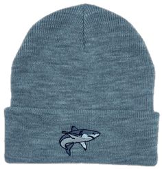 a blue hat with a shark embroidered on the front and side, it is knitted in