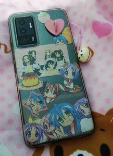 a phone case with anime characters on it next to a teddy bear and other items