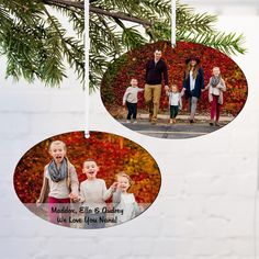 an ornament hanging from a tree with three pictures of people and two children